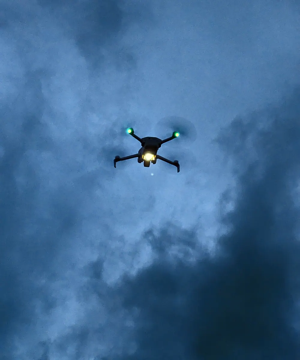 A drone in flight against a blue sky